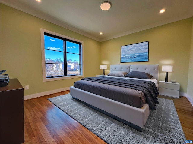 bedroom with baseboards, recessed lighting, and wood finished floors