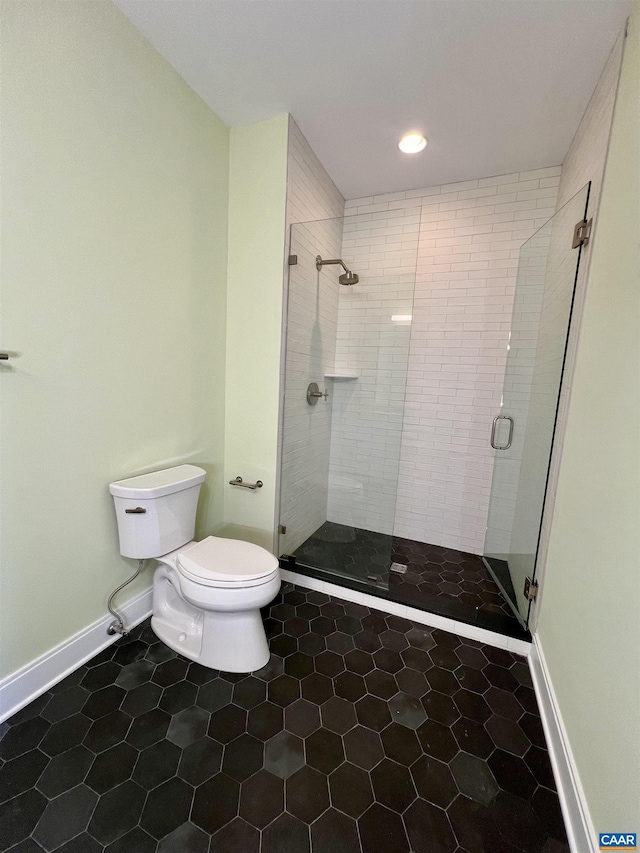 bathroom featuring toilet, a stall shower, baseboards, tile patterned flooring, and recessed lighting