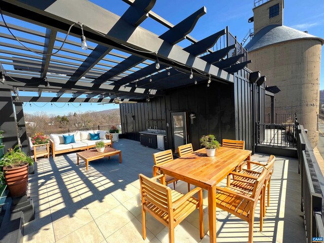 view of patio / terrace featuring outdoor dining area, a pergola, and an outdoor living space