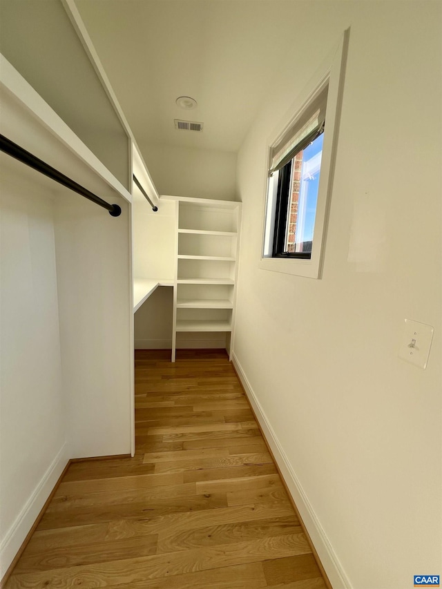 spacious closet featuring visible vents and light wood-style flooring