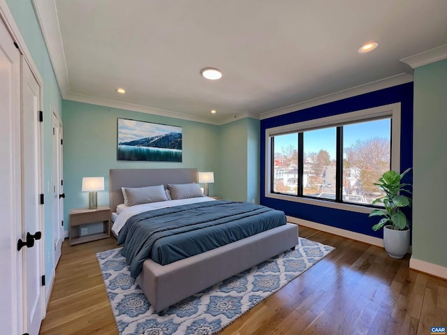 bedroom with ornamental molding, baseboards, recessed lighting, and wood finished floors