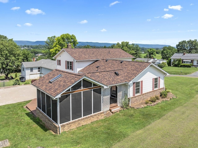 336 Hollingsworth Rd, Woodstock, VA 22664 - back of property with a sunroom, roof with shingles, a mountain view, stone siding, and a yard