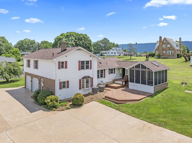 336 Hollingsworth Rd, Woodstock, VA 22664 - rear view of house with a wooden deck, a sunroom, a chimney, driveway, and brick siding