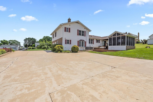336 Hollingsworth Rd, Woodstock, VA 22664 - back of house with a sunroom, a chimney, and a yard