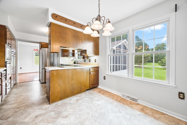 336 Hollingsworth Rd, Woodstock, VA 22664 - kitchen featuring a peninsula, a chandelier, light countertops, and healthy amount of natural light