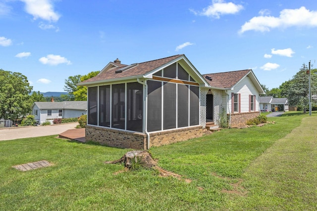 336 Hollingsworth Rd, Woodstock, VA 22664 - back of house featuring brick siding, a sunroom, a chimney, and a yard