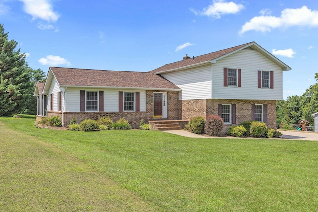 336 Hollingsworth Rd, Woodstock, VA 22664 - split level home featuring brick siding, a front yard, and a chimney