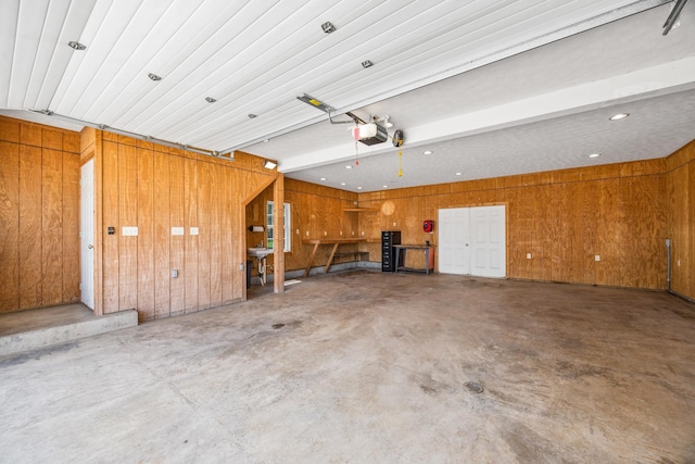 336 Hollingsworth Rd, Woodstock, VA 22664 - garage with a garage door opener, wood walls, and recessed lighting