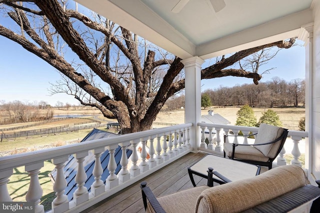 wooden deck featuring ceiling fan and fence