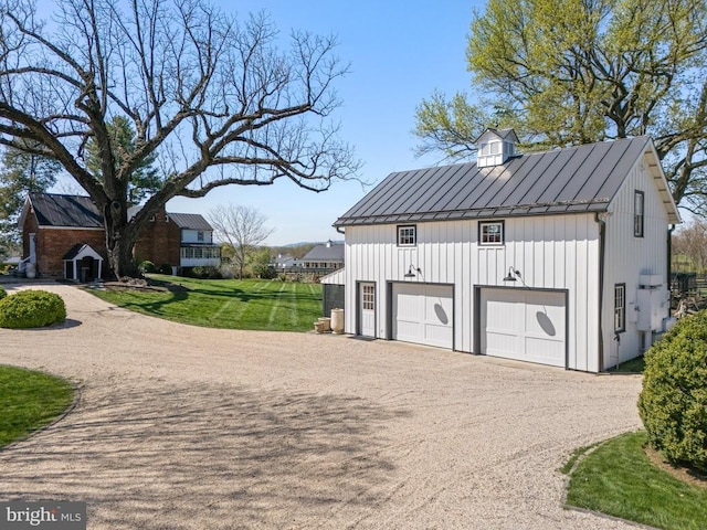garage featuring a garage and dirt driveway
