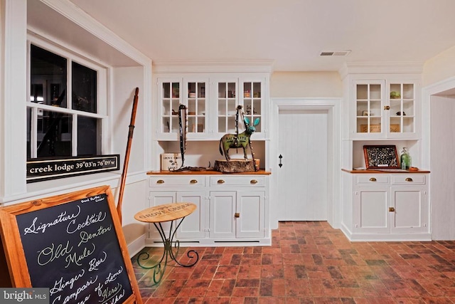 interior space featuring brick patterned floor and visible vents