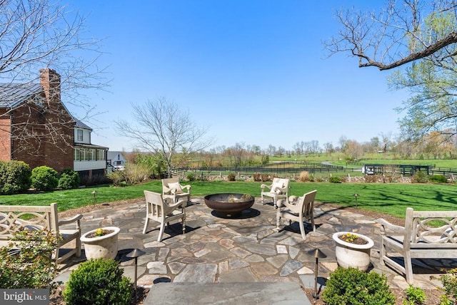 view of patio / terrace with an outdoor fire pit and fence
