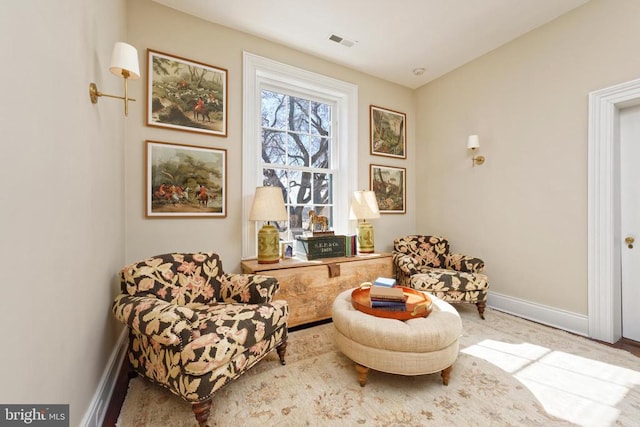 living area featuring visible vents and baseboards