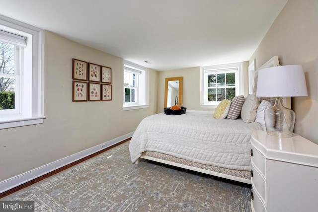 bedroom with multiple windows and baseboards