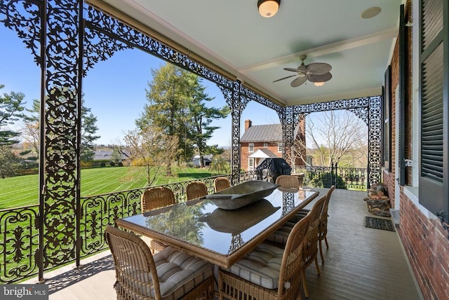 exterior space with outdoor dining area and ceiling fan