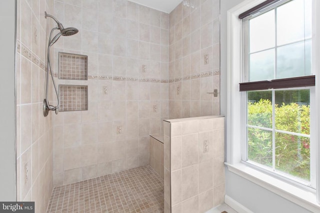 bathroom with tiled shower