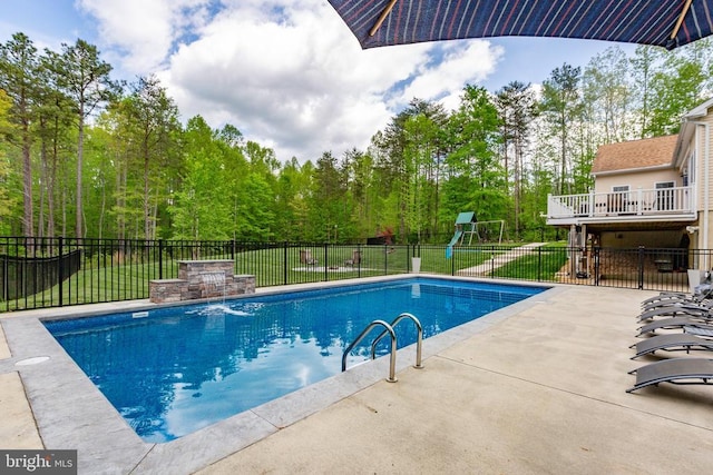 view of swimming pool featuring fence, a fenced in pool, a patio area, and a lawn
