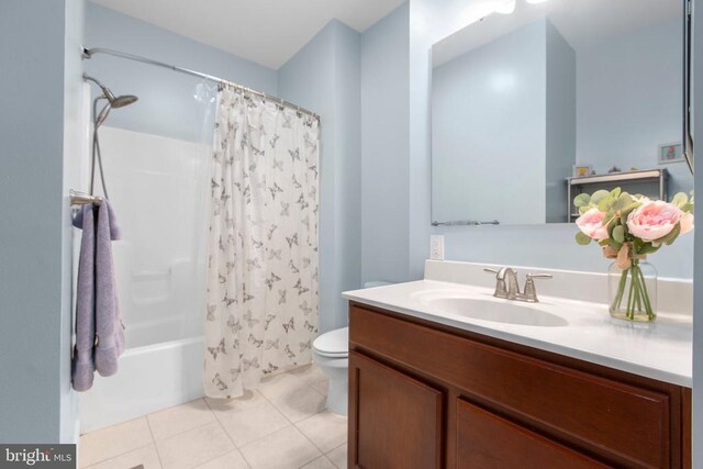 full bath with toilet, tile patterned flooring, vanity, and shower / bath combo