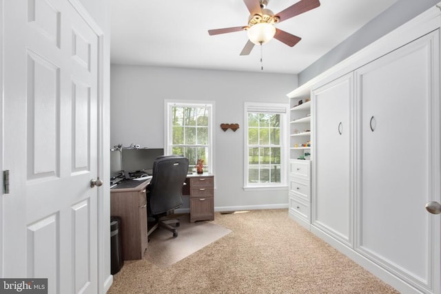 office area with light carpet, baseboards, and ceiling fan