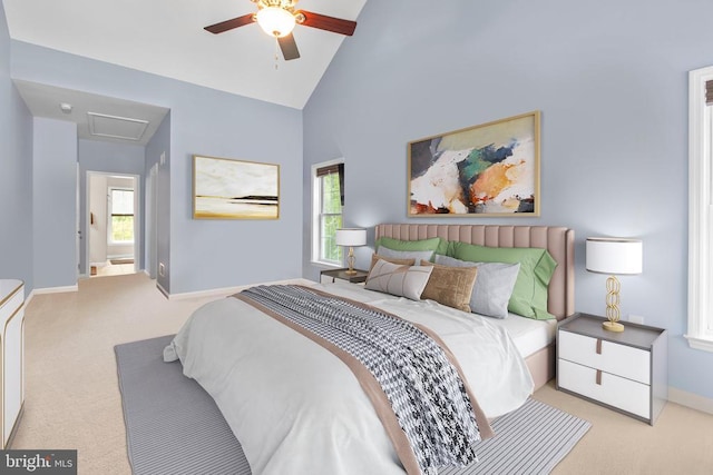 carpeted bedroom featuring baseboards, a ceiling fan, and high vaulted ceiling