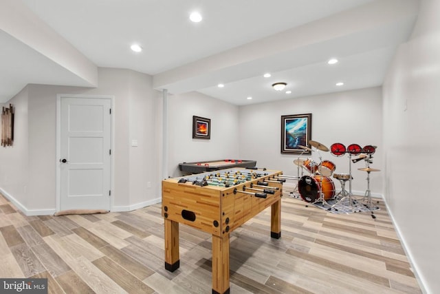 recreation room with baseboards, recessed lighting, and light wood-type flooring