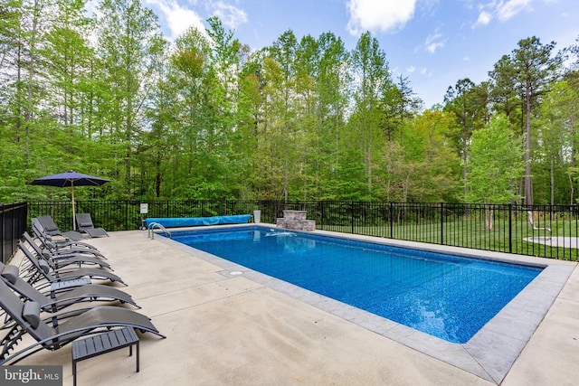 view of swimming pool featuring a patio, fence, and a fenced in pool