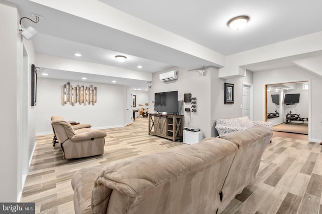 living area with light wood finished floors, baseboards, a wall unit AC, and recessed lighting