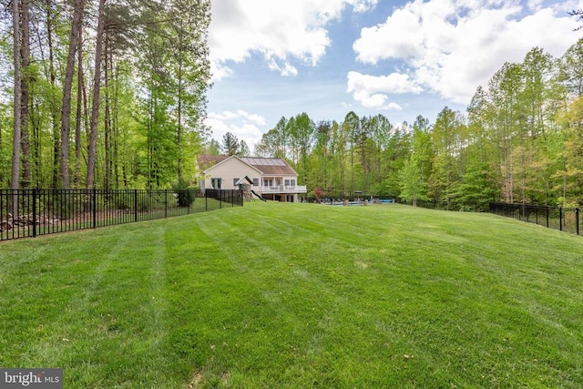view of yard featuring a forest view and fence
