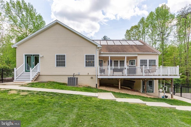 back of house featuring a yard, a deck, central air condition unit, and fence