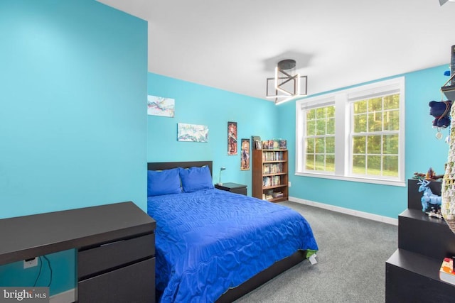 bedroom with baseboards and carpet floors