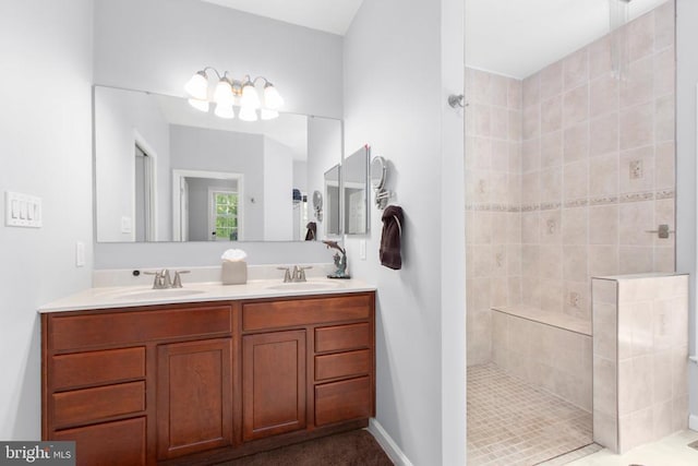 full bathroom featuring walk in shower, double vanity, and a sink