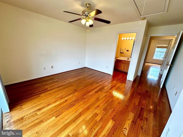 288 Lake Front Dr, Mineral, VA 23117 - unfurnished bedroom featuring attic access, wood finished floors, ensuite bath, a ceiling fan, and baseboards