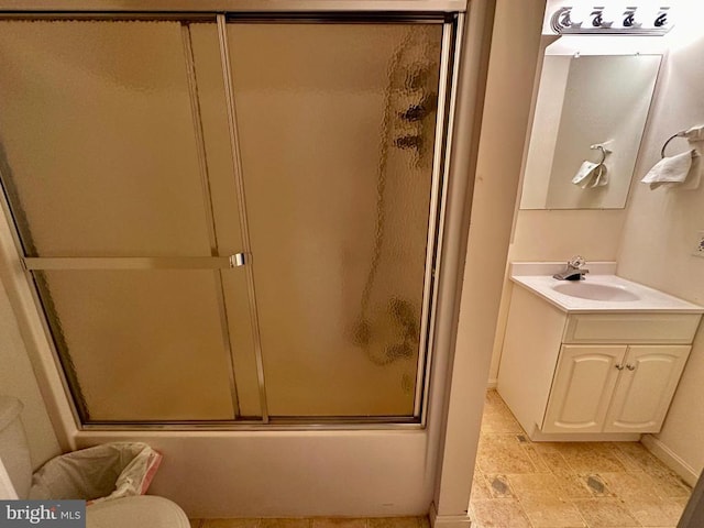 288 Lake Front Dr, Mineral, VA 23117 - full bath featuring baseboards, stone finish floors, shower / bath combination with glass door, vanity, and toilet