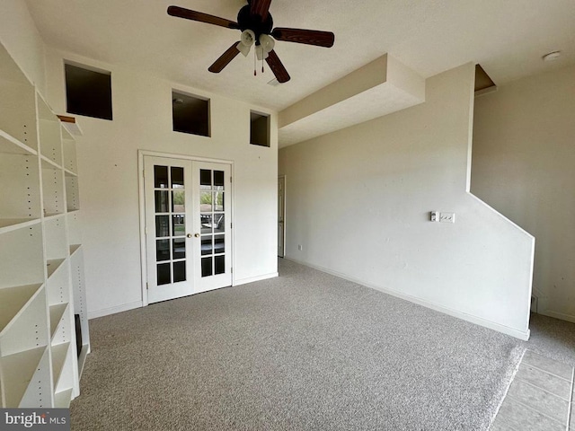 spare room with french doors, carpet floors, a ceiling fan, and baseboards