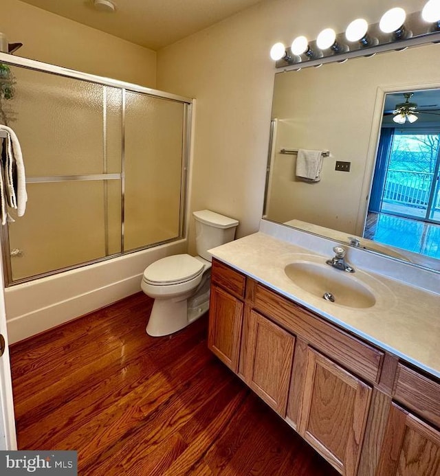 288 Lake Front Dr, Mineral, VA 23117 - bathroom with wood finished floors, ceiling fan, shower / bath combination with glass door, and toilet