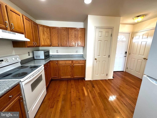 288 Lake Front Dr, Mineral, VA 23117 - kitchen featuring white appliances, under cabinet range hood, dark wood-style flooring, and brown cabinetry