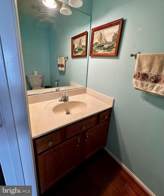 288 Lake Front Dr, Mineral, VA 23117 - bathroom featuring vanity, toilet, baseboards, and wood finished floors