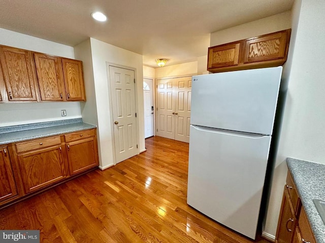 288 Lake Front Dr, Mineral, VA 23117 - kitchen featuring freestanding refrigerator, brown cabinets, wood finished floors, and recessed lighting