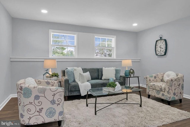  - living area with dark wood-style flooring and recessed lighting