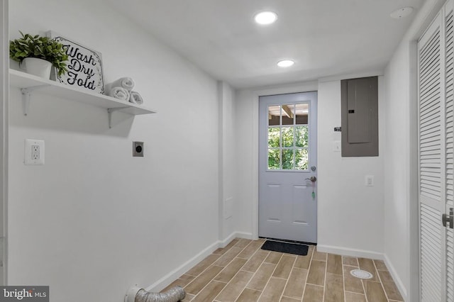  - doorway to outside featuring electric panel, recessed lighting, and light wood-style flooring