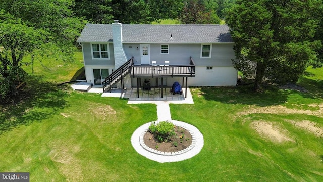  - back of property with a patio area, a chimney, a wooden deck, stairway, and a lawn