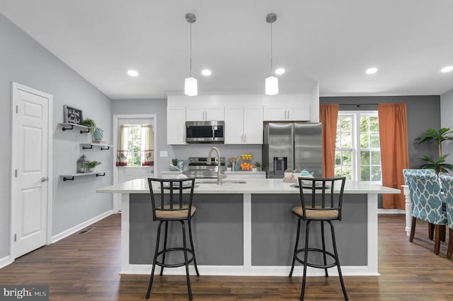  - kitchen with stainless steel appliances, a kitchen island with sink, plenty of natural light, light countertops, and recessed lighting