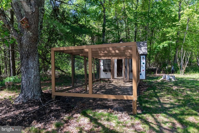  - view of outbuilding featuring a forest view