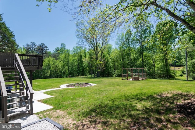  - view of green lawn featuring stairway, a garden, and a wooden deck