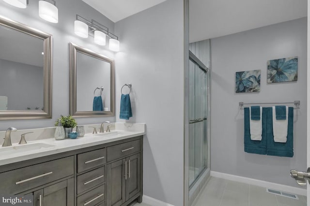  - bathroom featuring double vanity, a stall shower, and tile patterned floors