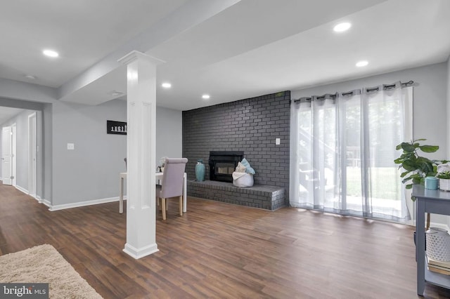  - living room with wood finished floors, a brick fireplace, and recessed lighting