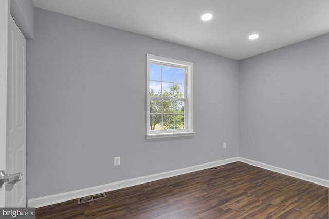  - empty room featuring dark wood-style flooring and recessed lighting