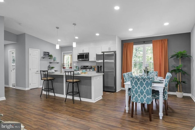  - dining space with dark wood finished floors and recessed lighting