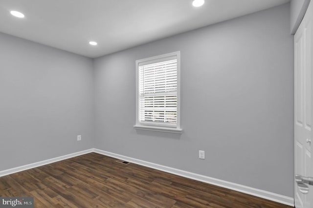  - spare room featuring recessed lighting and dark wood-style flooring