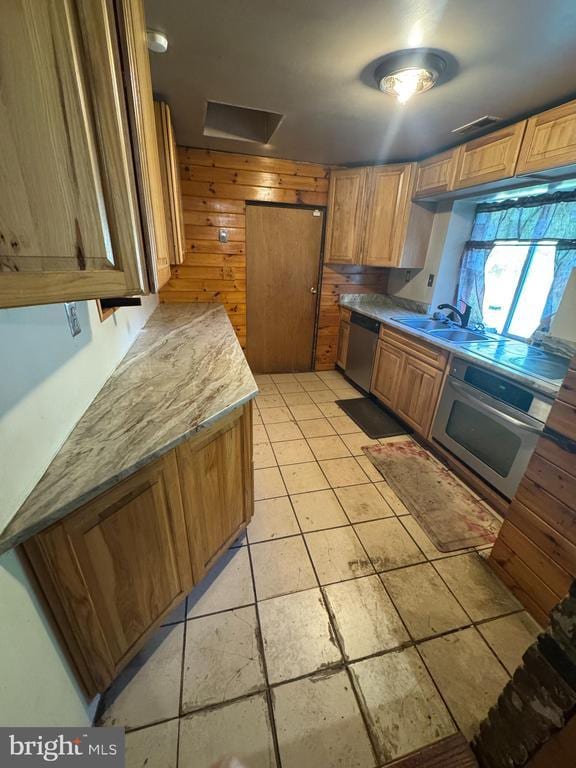 11418 Cox Ml, Gordonsville, VA 22942 - kitchen featuring stainless steel appliances, a sink, light tile patterned flooring, light countertops, and brown cabinetry